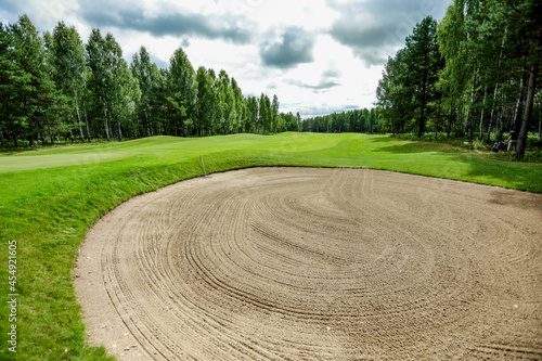 Beautiful golf course with a sand trap. High quality photo