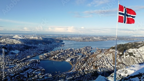 Flag on the top of the mountain, view of the fjords
