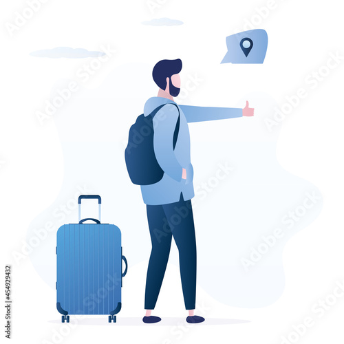 Hitchhiker with luggage on the road and thumb up. Autostop, concept. Time to travel the world, holidays, summer vacations. Male tourist with backpack
