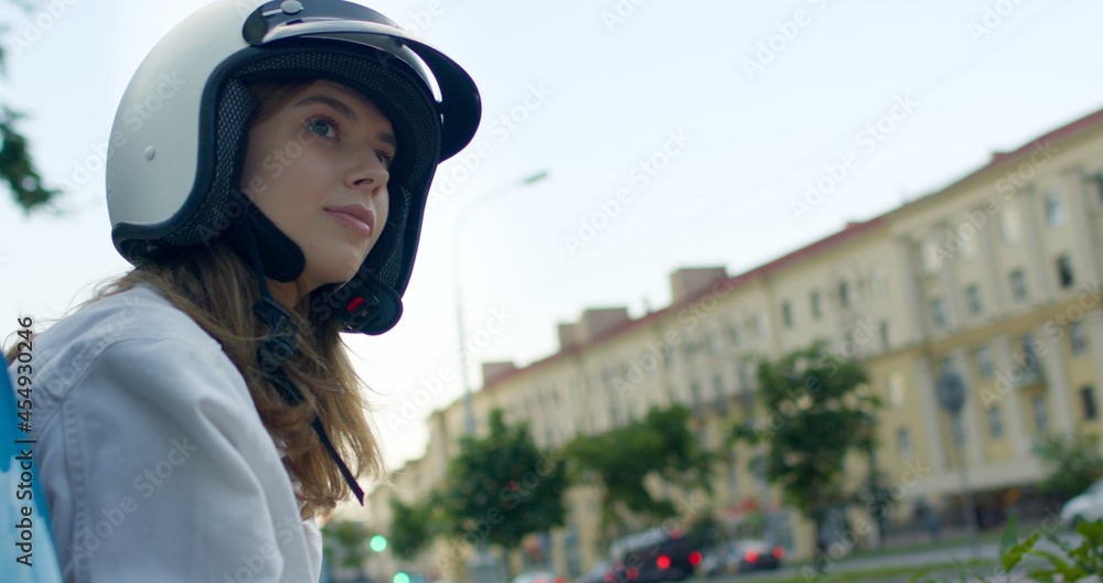 girl sits on bike and looks at city girl sits on bike and looks at city