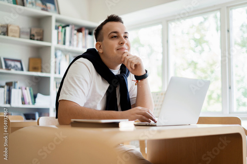 Online distance learning in college in the classroom. Searches for the necessary information on the library's website. Smart institute student types and surf the internet.