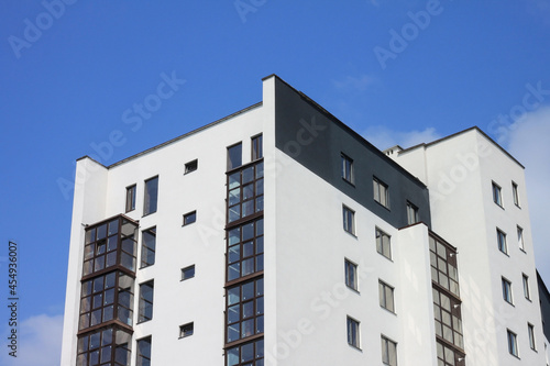 Construction of modern multi-storey building on blue cloudy sky background
