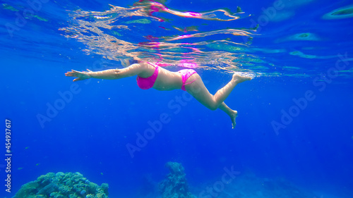 a young beautiful girl with a beautiful figure swims in the red sea is engaged in snorkeling