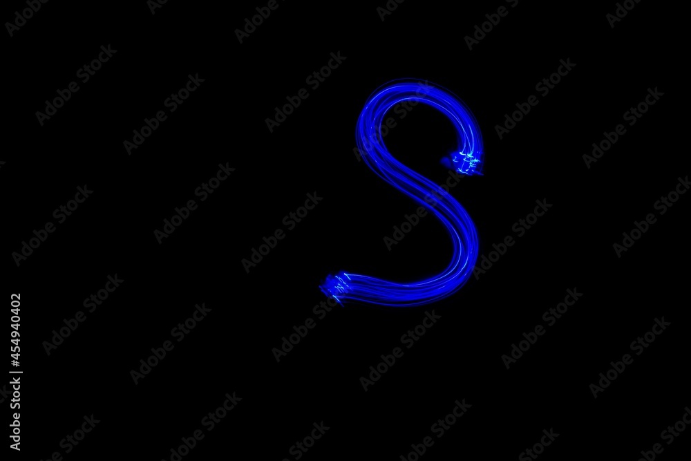 Drawn letter S with blue lights against black background. Light painting alphabet. Drawn letter S with blue lights against black background. Light painting alphabet.