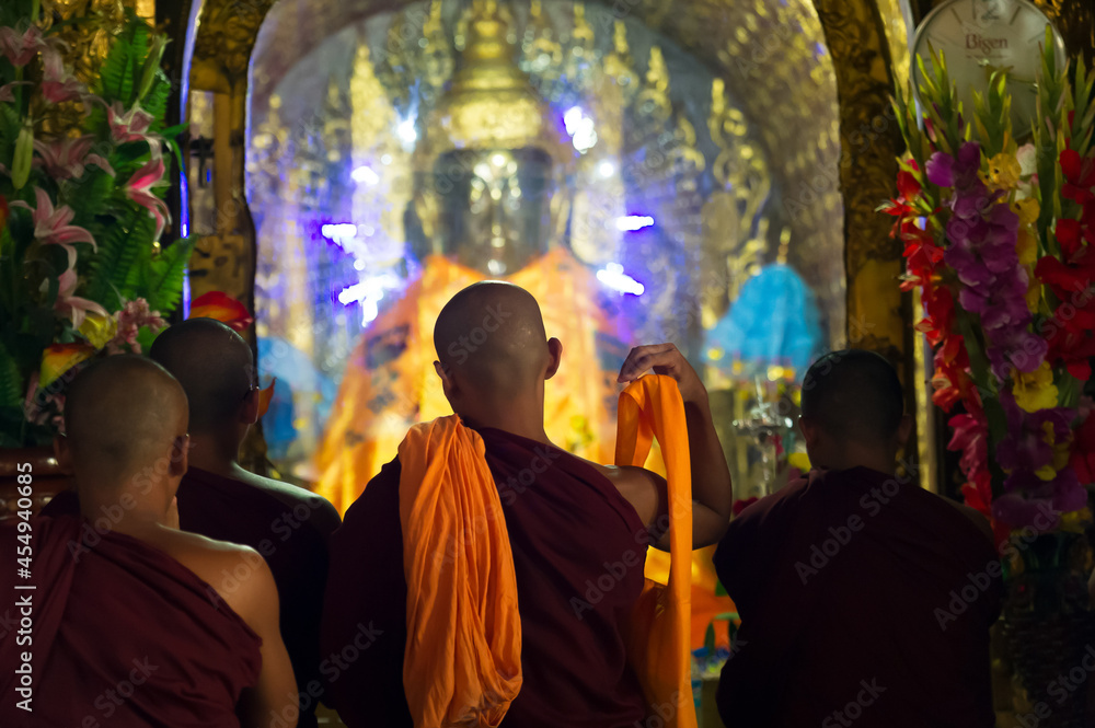 Myanmar. Yangon. Monks front of a Buddha at Shwedagon Pagoda Myanmar. Yangon. Monks front of a Buddha at Shwedagon Pagoda