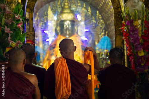 Myanmar. Yangon. Monks front of a Buddha at Shwedagon Pagoda