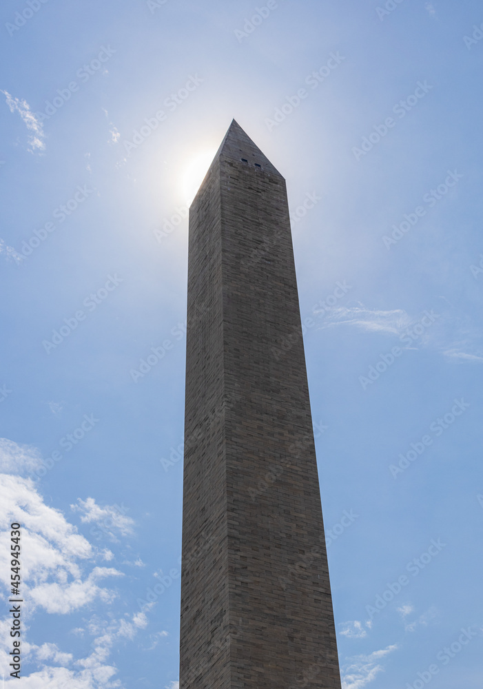 Sun behind the tip of the Washington Monument in Washington DC