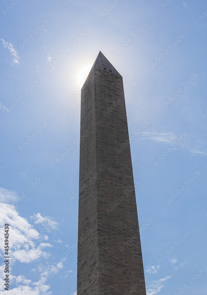 Sun behind the tip of the Washington Monument in Washington DC Sun behind the tip of the Washington Monument in Washington DC