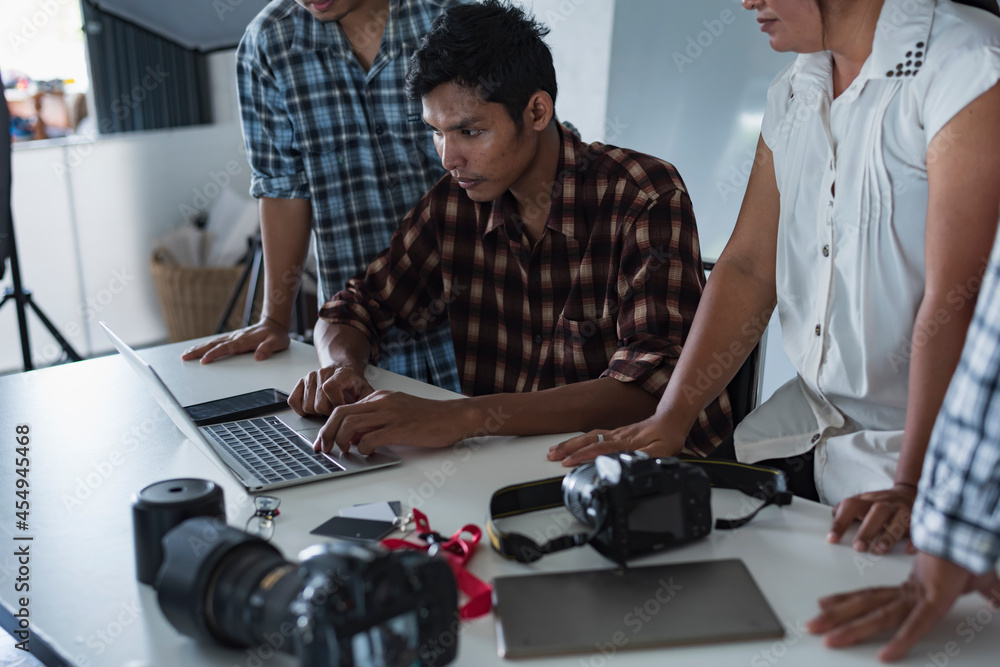Multiethnic group of young people sitting in conference room and brainstorming on business meeting. Multiethnic group of young people sitting in conference room and brainstorming on business meeting.