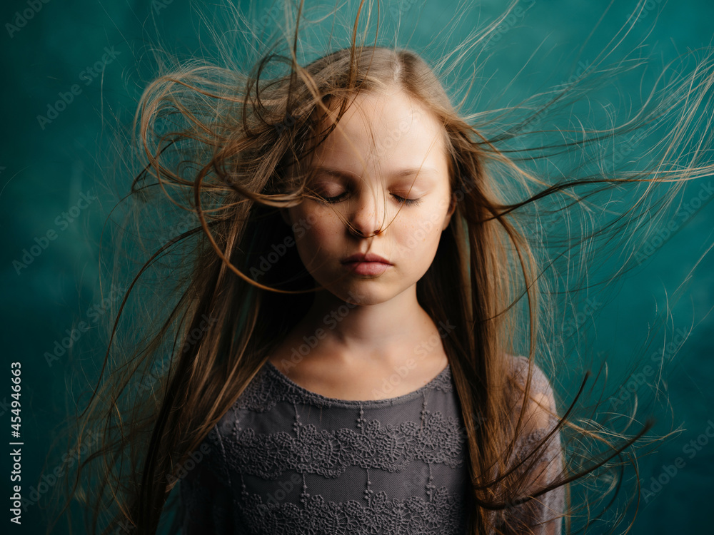 girl with closed eyes and loose hair close up isolated background