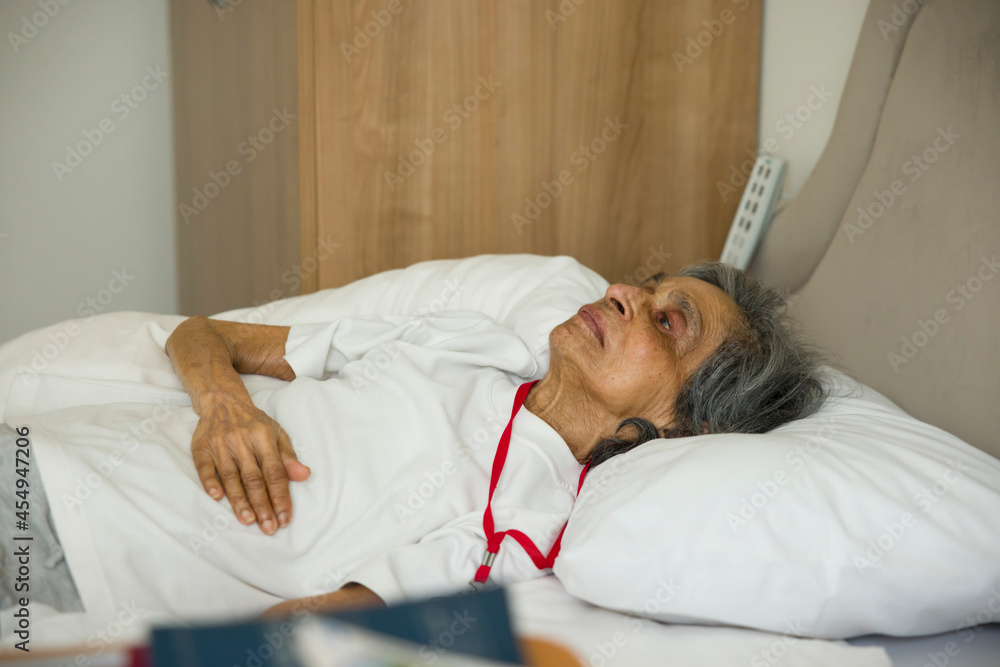 Frail old woman lying in a bed in hospital or nursing home, UK Stock Photo  | Adobe Stock