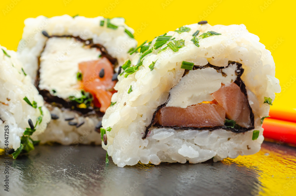 Closeup of smoked salmon, soft cheese and chive California roll Closeup of smoked salmon, soft cheese and chive California roll