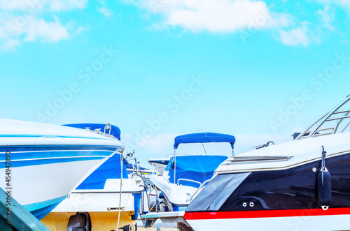Boat on stand on the shore, close up on the part of the yacht, luxury ship, maintenance and parking place boat