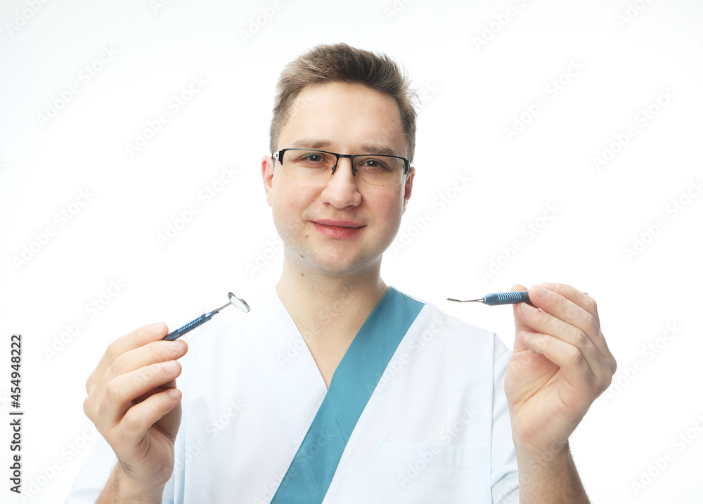 Dentist man holding tools on white background, Dentistry and medicine concept. Dentist man holding tools on white background, Dentistry and medicine concept.
