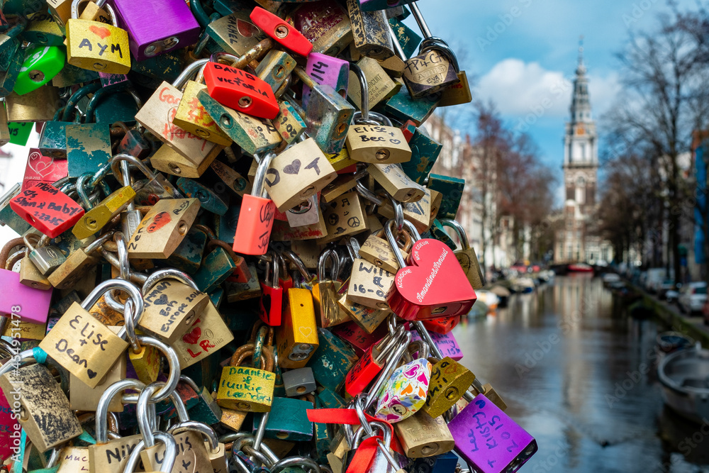 Obraz premium Love locks hang on the Staalbrug over the Groenburgwal in Amsterdam, Noord-Holland Province, The Netherlands