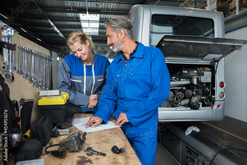 man and woman mechanic discussing repairs