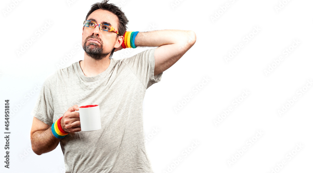 Obraz premium Dark haired man wearing glasses and a bracelet with rainbow colors; with tired expression