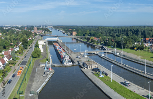 Fototapeta Shipping container at the Wijnegem lock at the Albert Canal, Antwerp, Belgium