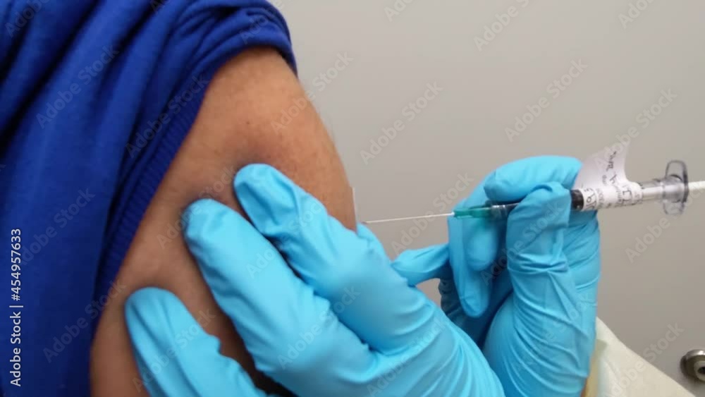Vaccine shot in arm close-up administration COVID-19 prevention second dose Vaccine shot in arm close-up administration COVID-19 prevention second dose