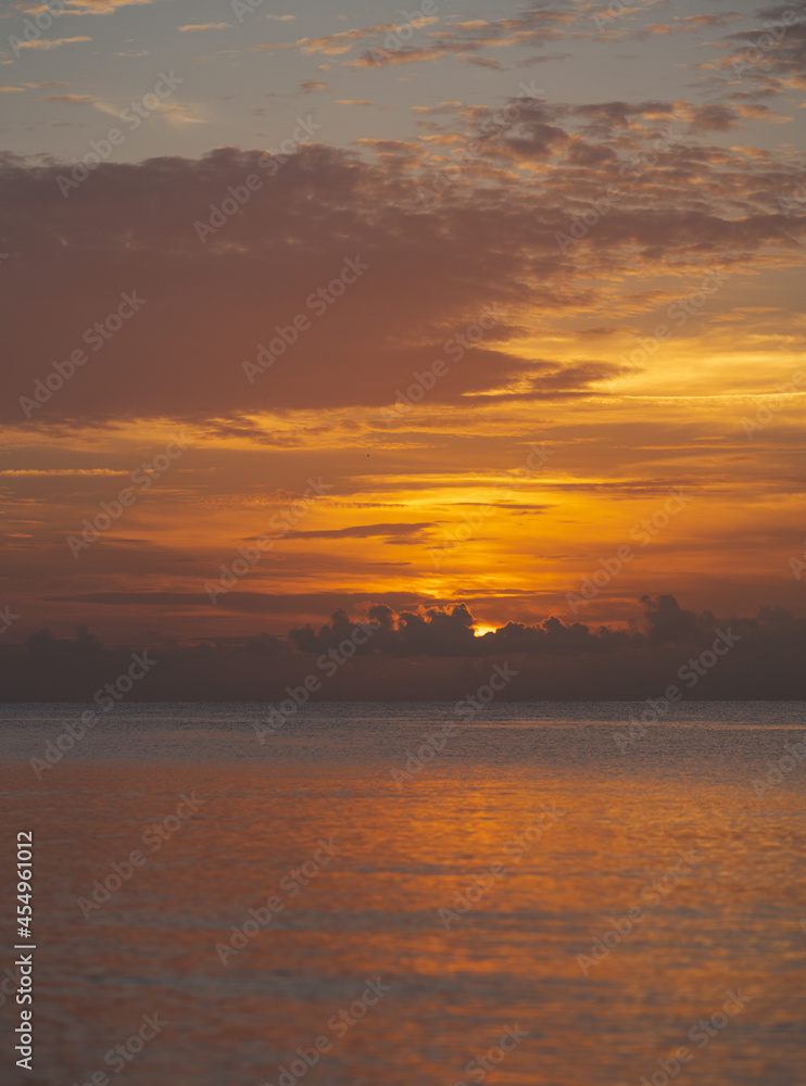 sunset over the ocean sunrise  sky beautiful clouds horizon sun nature 