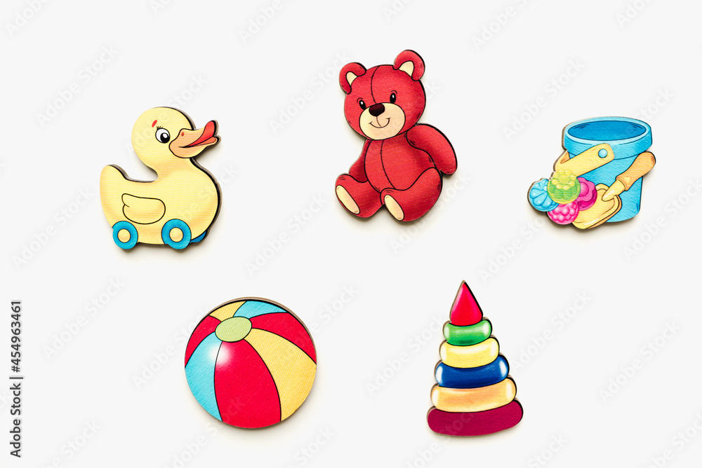 Fototapeta premium Children's puzzles made of wood. Childrens toys made of wood on a white background. Children's pictures. Educational toys.