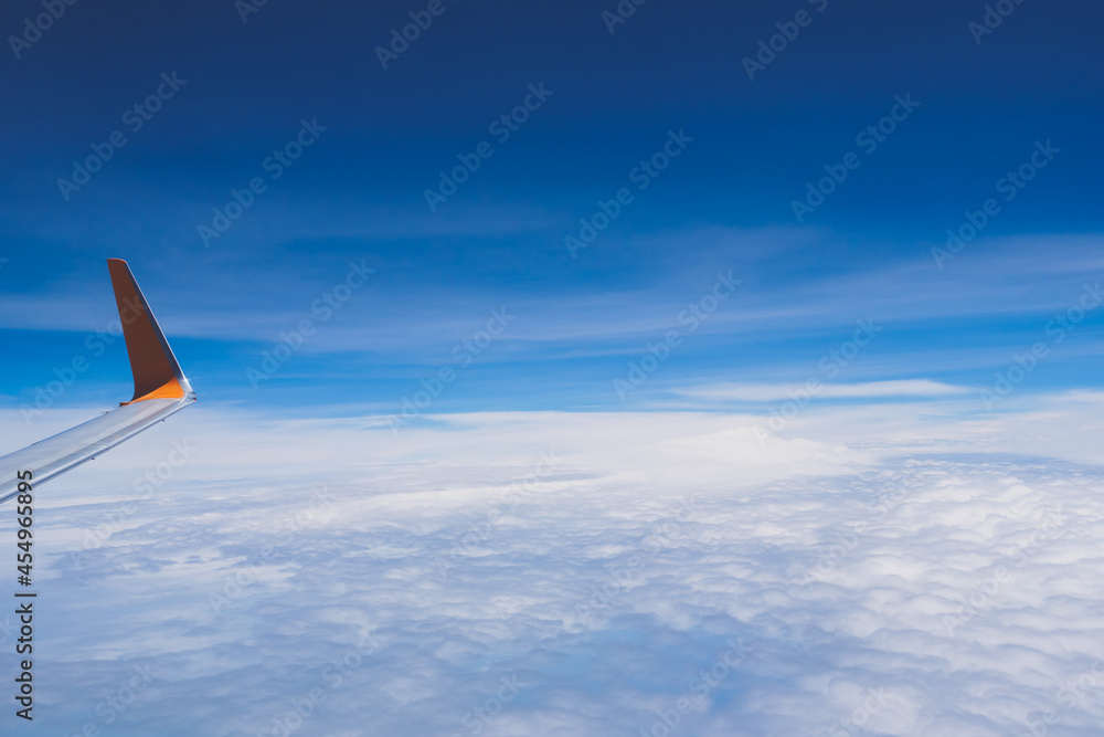 The wing tips of the airplane against the clear blue sky background while travelling in the summer with copyspace. The wing tips of the airplane against the clear blue sky background while travelling in the summer with copyspace.