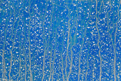 Abstract blue background. Empty surface. Traces or splashes from water. Back for design