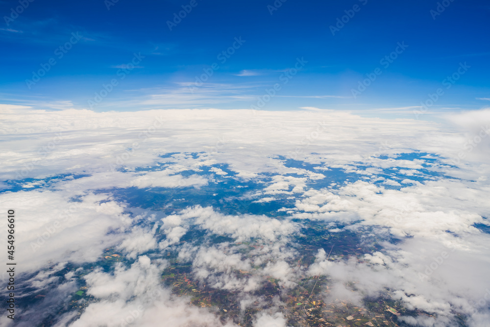 Aerial view scene of the mountain, meadow and abundant rice which hiding under white fluffy clouds and blue bright sky background. Aerial view scene of the mountain, meadow and abundant rice which hiding under white fluffy clouds and blue bright sky background.