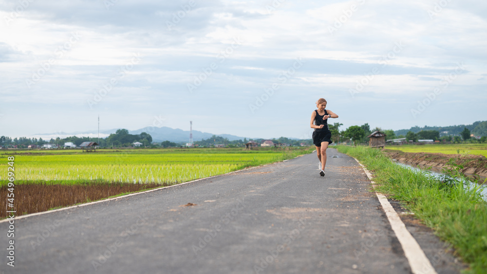 Woman using smart watch during training outdoors. Woman using smart watch during training outdoors.