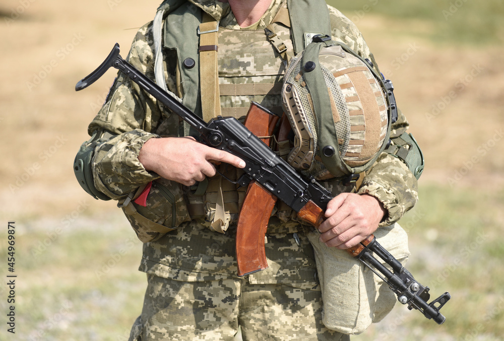 Soldier of Ukraine Ukrainian soldier with assault rifle AK.