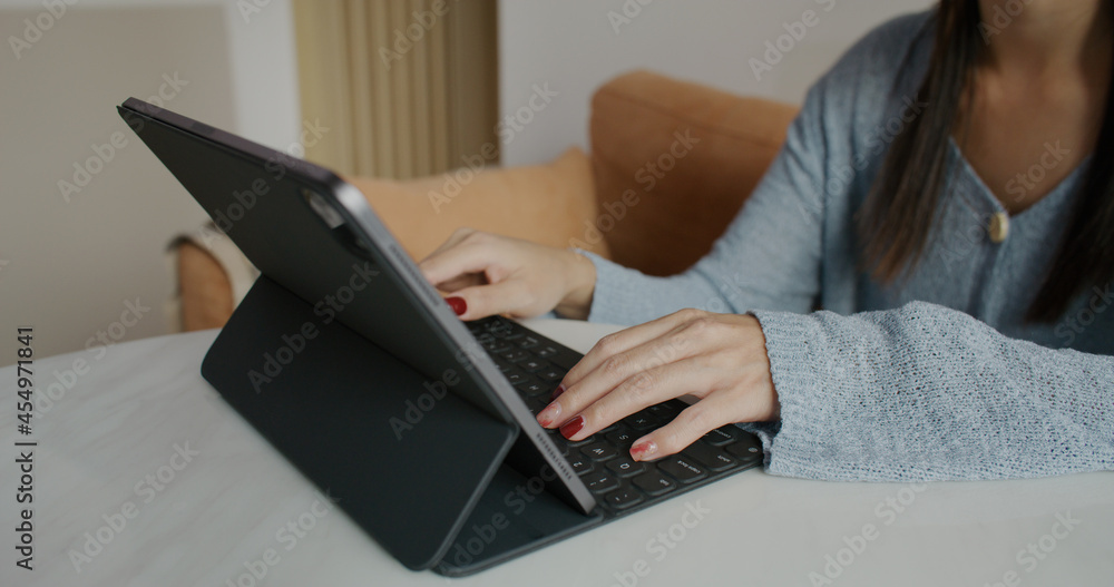 Woman work on tablet computer at home Woman work on tablet computer at home