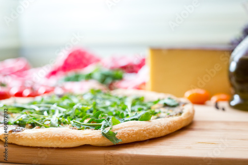 Focaccia with  rucola  and cheese on wooden board