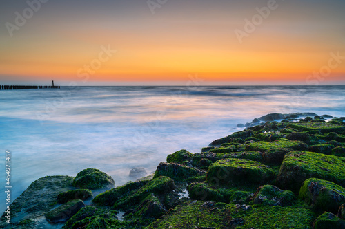 Dusk at Breakwater in a stormy sea in summer © fotografiecor