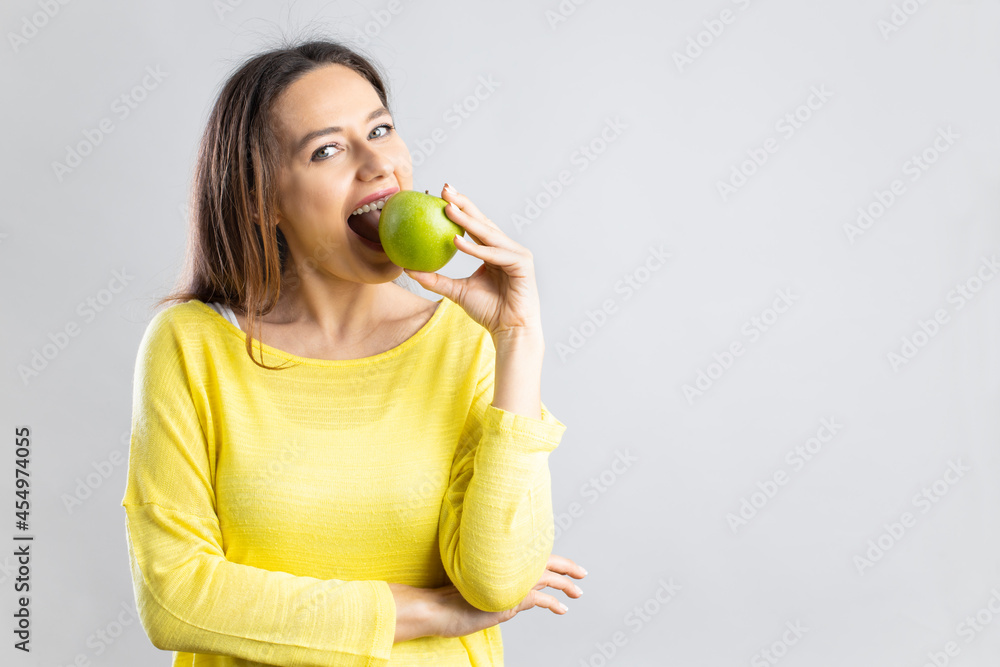 Young woman eating green apple. Young woman eating green apple.