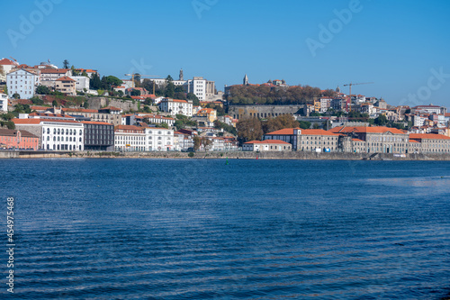 Walking along Douro river from Porto to Atlantic ocean coast and view on river and houses of Porto, Portugal