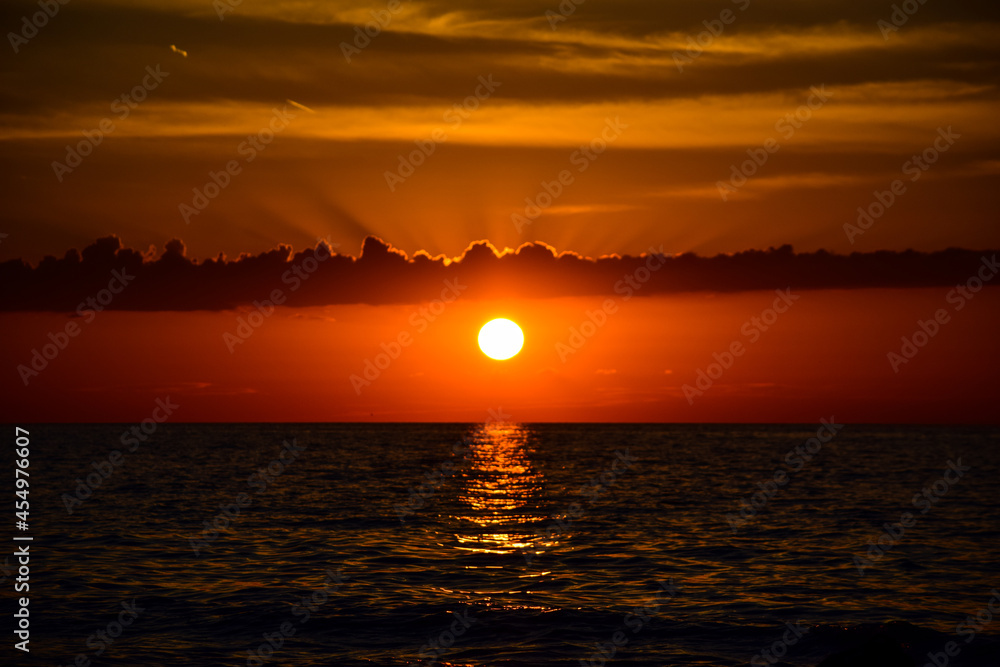 Sun setting under the clouds