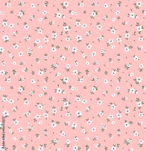 Vintage floral background. Floral pattern with small white flowers on alight pink background. Seamless pattern for design and fashion prints. Ditsy style. Stock vector illustration.