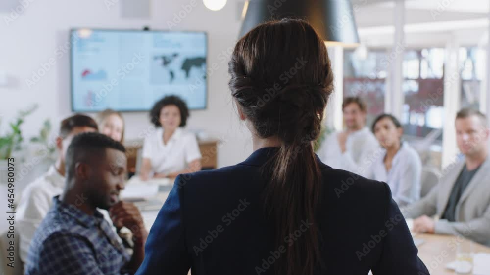 rear view business woman executive meeting with colleagues in boardroom sharing leadership ideas discussing management strategy briefing shareholders in office 4k rear view business woman executive meeting with colleagues in boardroom sharing leadership ideas discussing management strategy briefing shareholders in office 4k