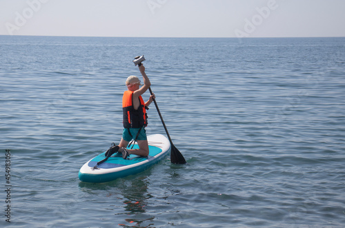 boy sailing on Sup board in the sea