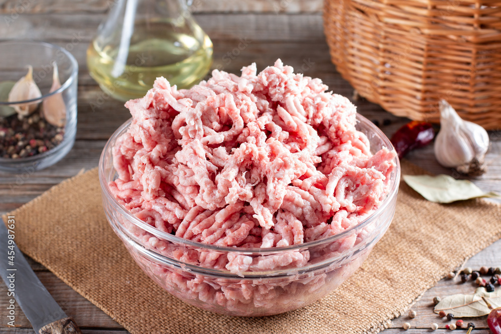 Fresh pork minced meat in a plate on a table Fresh pork minced meat in a plate on a table