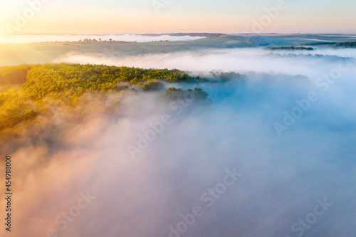 Awesome misty view of the countryside with the rays of morning light.