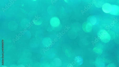 green abstract background of blurred lights with bokeh effect