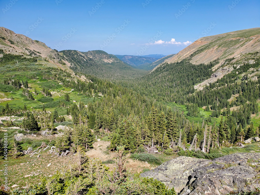 Mountains, forests and valleys of Indian Peaks Wilderness in Arapaho National Forest, Colorado on clear sunny summer afternoon.