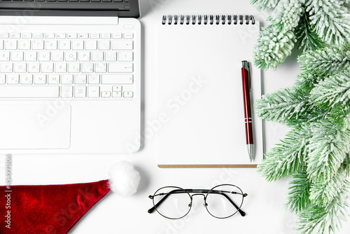 Christmas composition, notebook, santa hat, notebook, pen, fir branches.