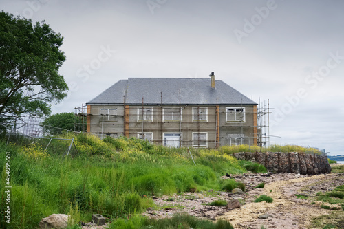 Derelict council house in poor housing area at coastal location photo