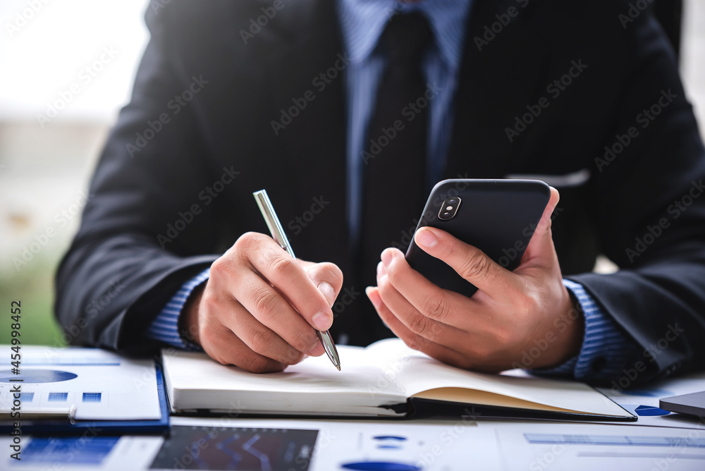 Businessman calculating on charts and graphs showing successful performance business idea Businessman calculating on charts and graphs showing successful performance business idea