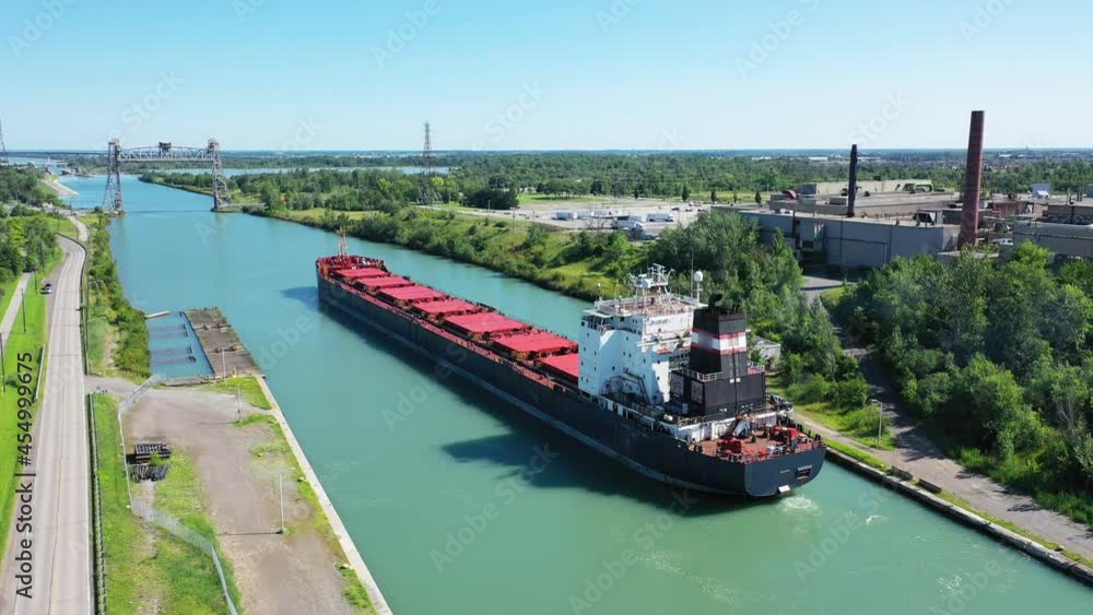 Aerial view of a Lake Freighter leaving a lock in the Welland Canal, Canada 4K Aerial view of a Lake Freighter leaving a lock in the Welland Canal, Canada 4K