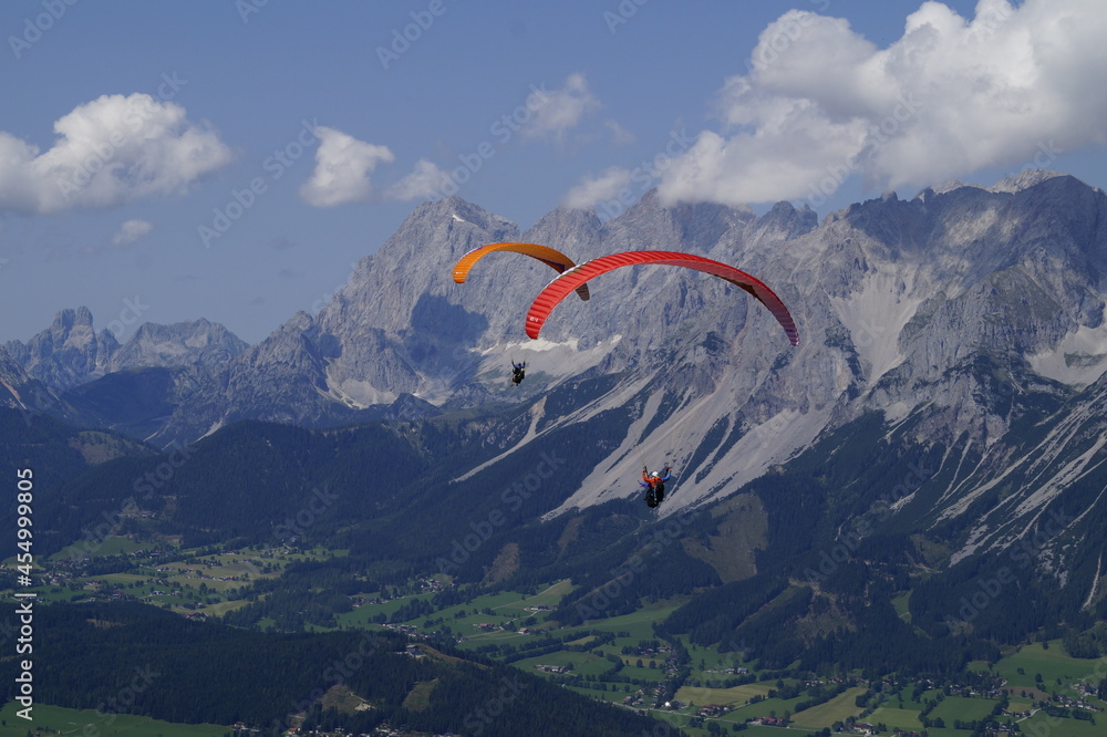 two friends paragliding in the Alps of the Schladming-Dachstein region in Austria
two friends paragliding in the Alps of the Schladming-Dachstein region in Austria
