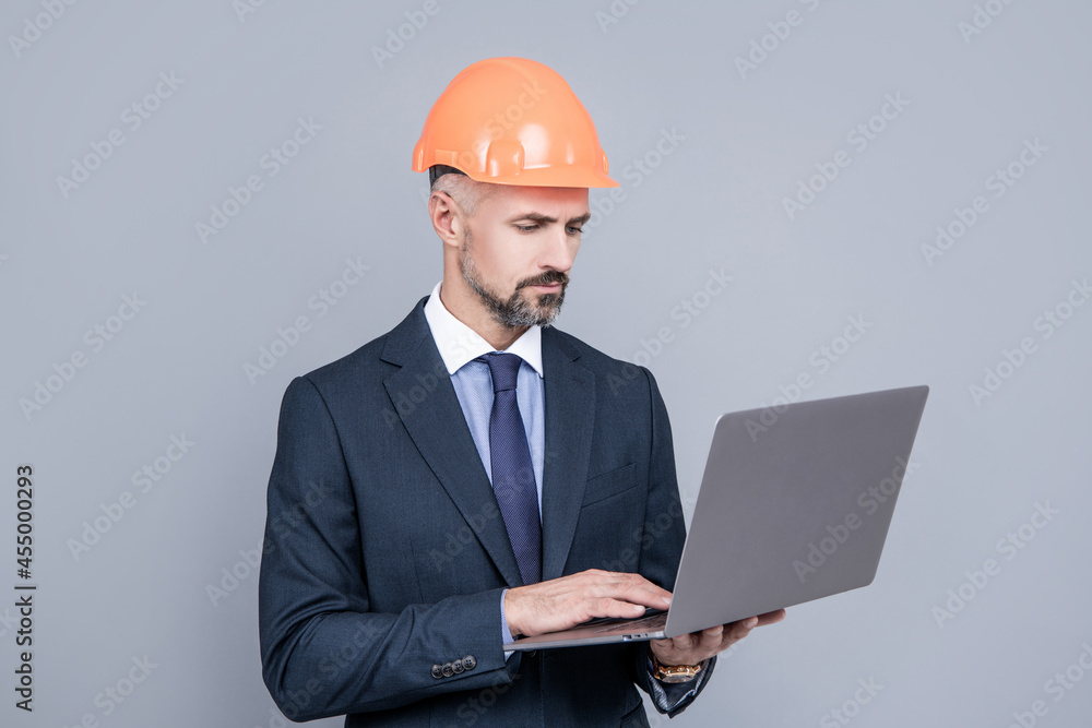 businessman man in building helmet using computer, safety online conference businessman man in building helmet using computer, safety online conference