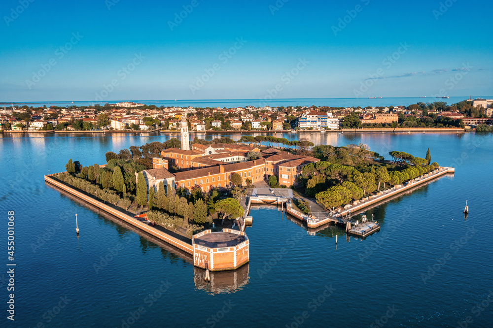 Flying over small Venice islands located in the middle of the Venetian lagoon. Beautiful aerial view of Venice.